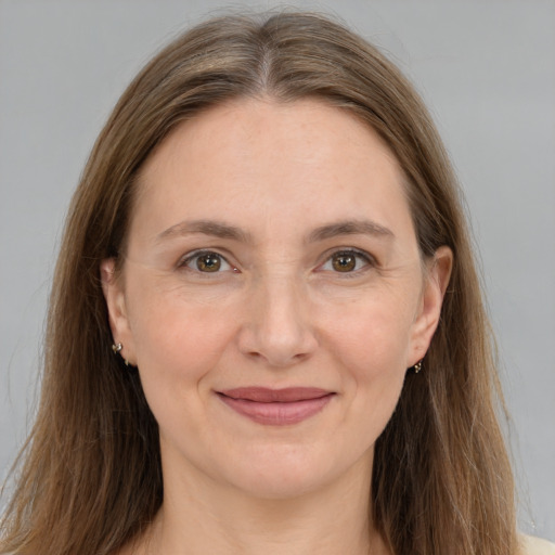 Joyful white young-adult female with long  brown hair and grey eyes