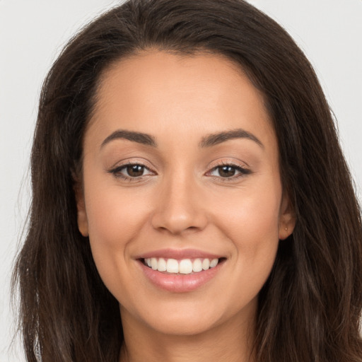 Joyful white young-adult female with long  brown hair and brown eyes