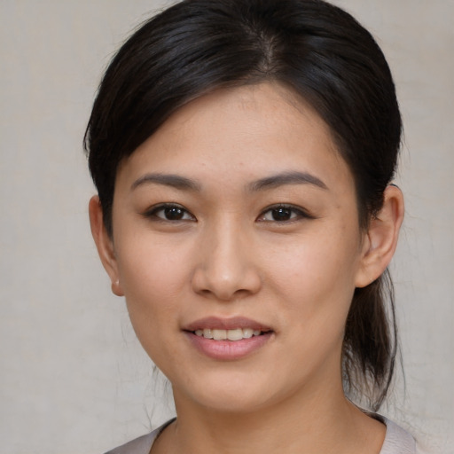 Joyful asian young-adult female with medium  brown hair and brown eyes