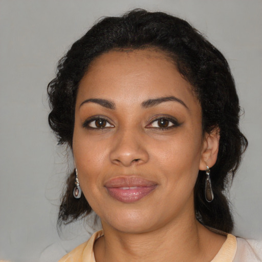 Joyful black adult female with medium  black hair and brown eyes