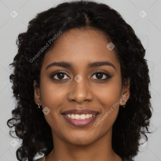 Joyful black young-adult female with long  black hair and brown eyes