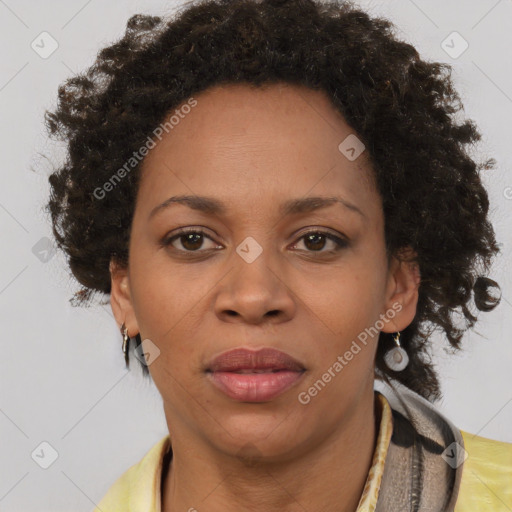 Joyful black adult female with short  brown hair and brown eyes