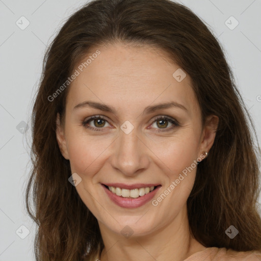 Joyful white adult female with long  brown hair and brown eyes