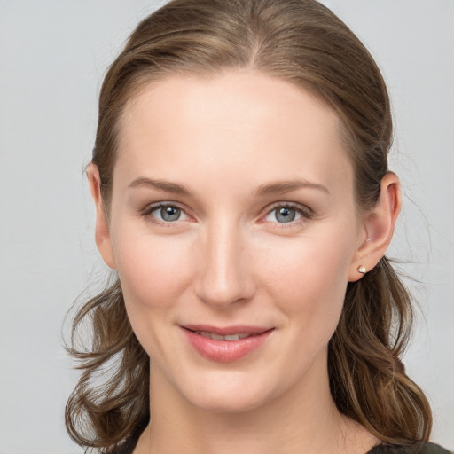 Joyful white young-adult female with long  brown hair and grey eyes