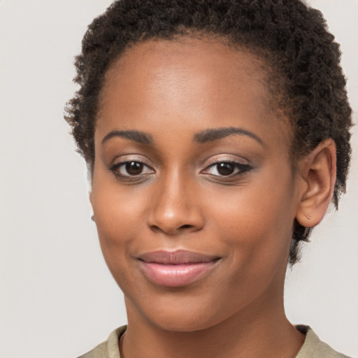 Joyful black young-adult female with short  brown hair and brown eyes