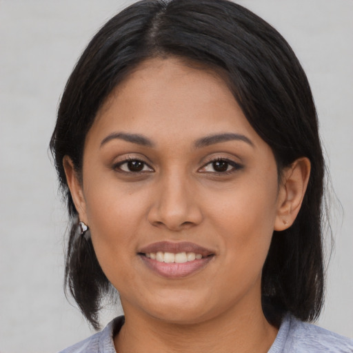 Joyful asian young-adult female with medium  black hair and brown eyes
