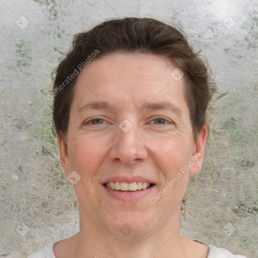 Joyful white adult female with short  brown hair and grey eyes