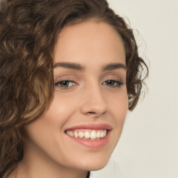 Joyful white young-adult female with medium  brown hair and green eyes