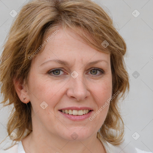 Joyful white adult female with medium  brown hair and blue eyes