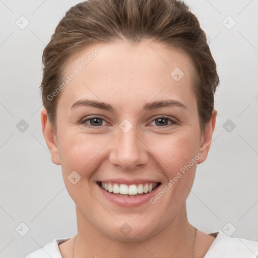 Joyful white young-adult female with short  brown hair and grey eyes