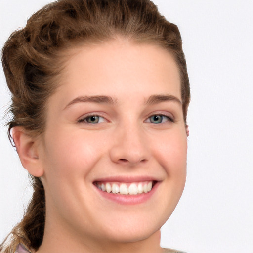 Joyful white young-adult female with long  brown hair and blue eyes