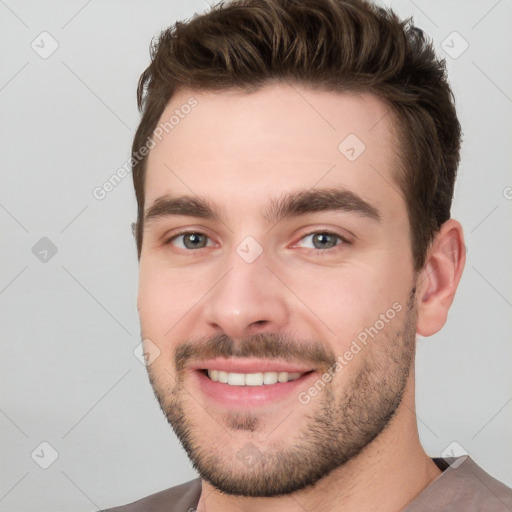 Joyful white young-adult male with short  brown hair and brown eyes