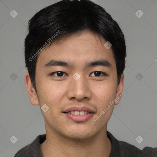 Joyful asian young-adult male with short  brown hair and brown eyes