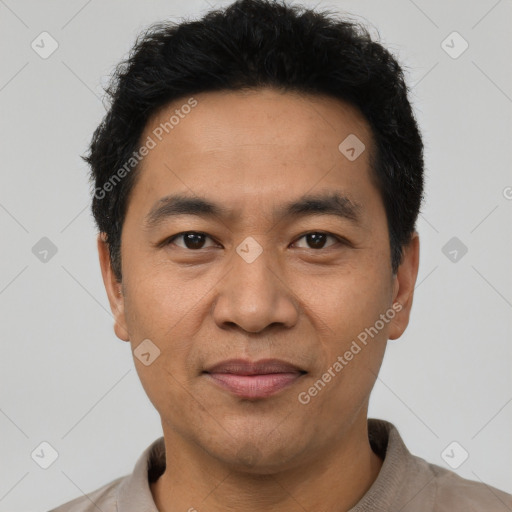 Joyful asian adult male with short  black hair and brown eyes