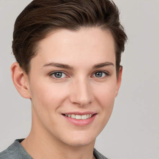 Joyful white young-adult female with short  brown hair and grey eyes