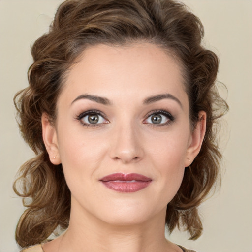 Joyful white young-adult female with medium  brown hair and green eyes