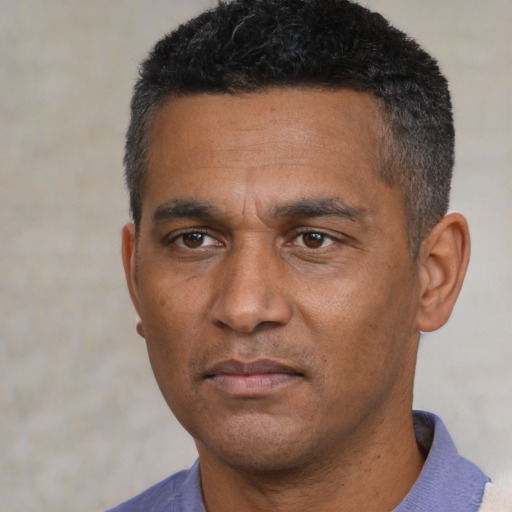 Neutral black adult male with short  black hair and brown eyes