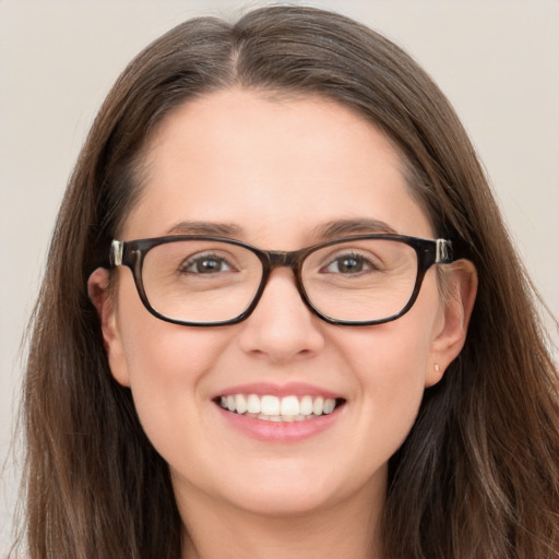 Joyful white young-adult female with long  brown hair and blue eyes