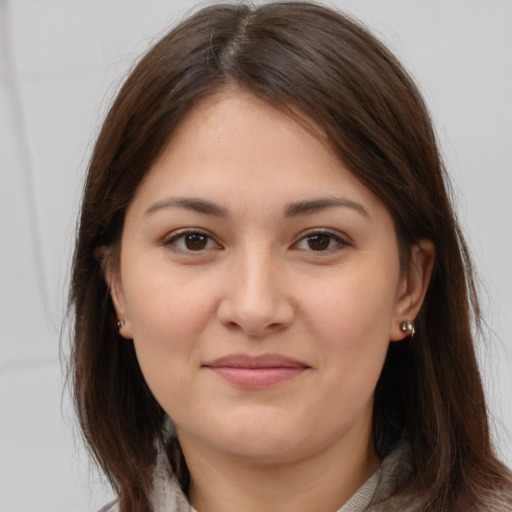 Joyful white young-adult female with medium  brown hair and brown eyes