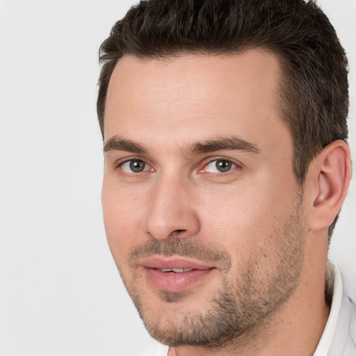 Joyful white young-adult male with short  brown hair and brown eyes