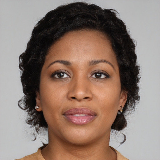 Joyful black young-adult female with medium  brown hair and brown eyes
