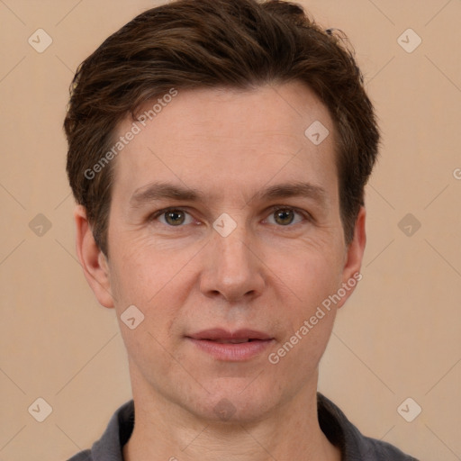 Joyful white adult male with short  brown hair and grey eyes