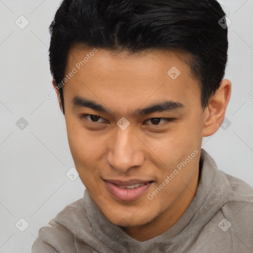 Joyful latino young-adult male with short  brown hair and brown eyes