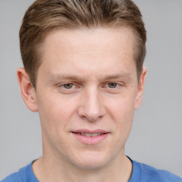 Joyful white adult male with short  brown hair and grey eyes