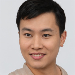 Joyful asian young-adult male with short  brown hair and brown eyes