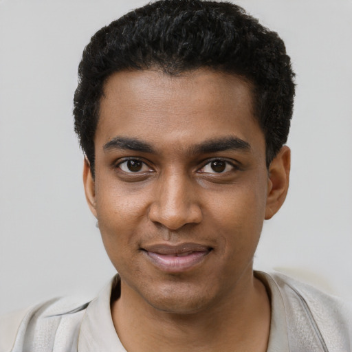 Joyful black young-adult male with short  black hair and brown eyes