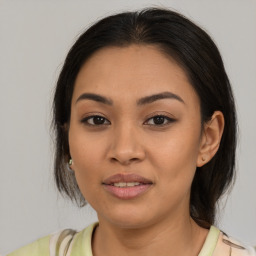 Joyful latino young-adult female with medium  brown hair and brown eyes