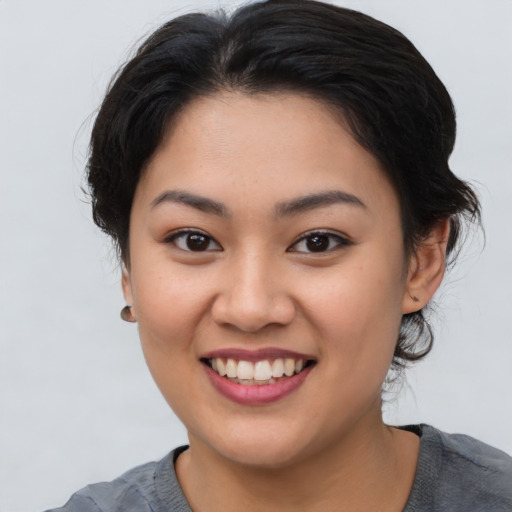 Joyful asian young-adult female with medium  brown hair and brown eyes