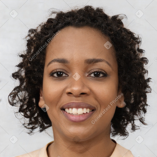 Joyful black young-adult female with medium  brown hair and brown eyes