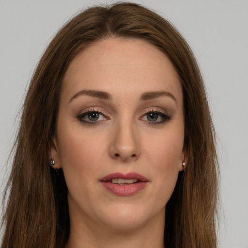 Joyful white young-adult female with long  brown hair and green eyes