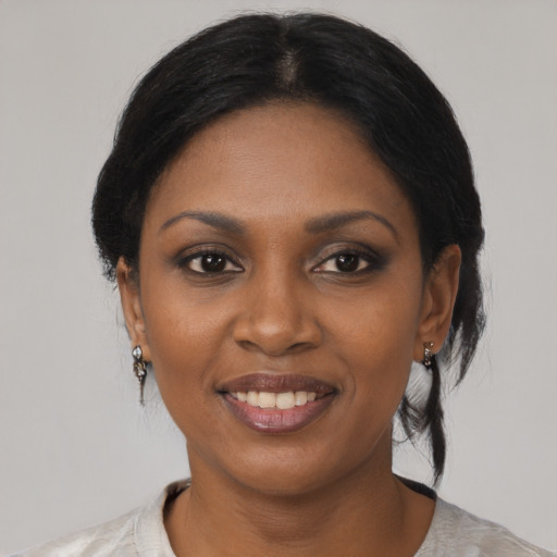 Joyful black young-adult female with medium  black hair and brown eyes