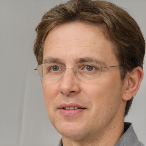 Joyful white adult male with short  brown hair and grey eyes