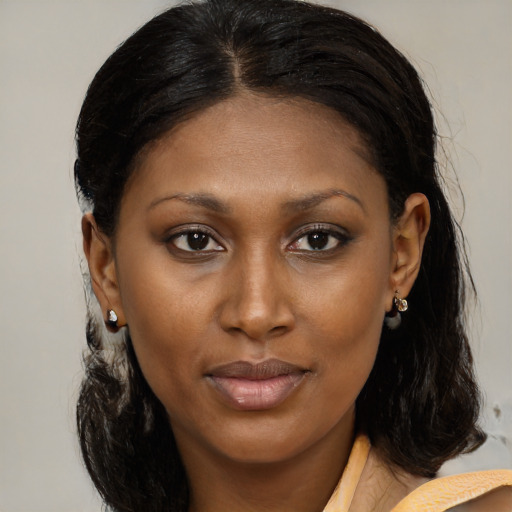Joyful black young-adult female with medium  brown hair and brown eyes