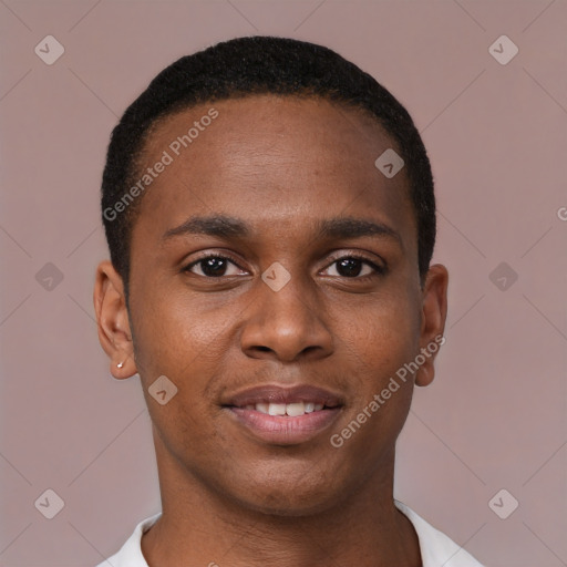 Joyful black young-adult male with short  brown hair and brown eyes