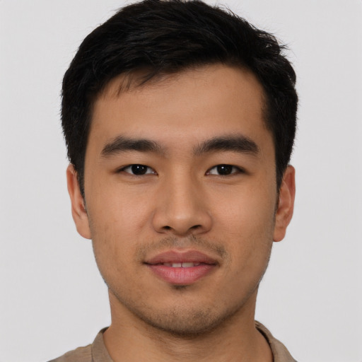 Joyful asian young-adult male with short  black hair and brown eyes