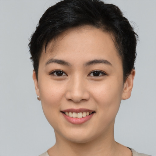 Joyful asian young-adult female with short  brown hair and brown eyes
