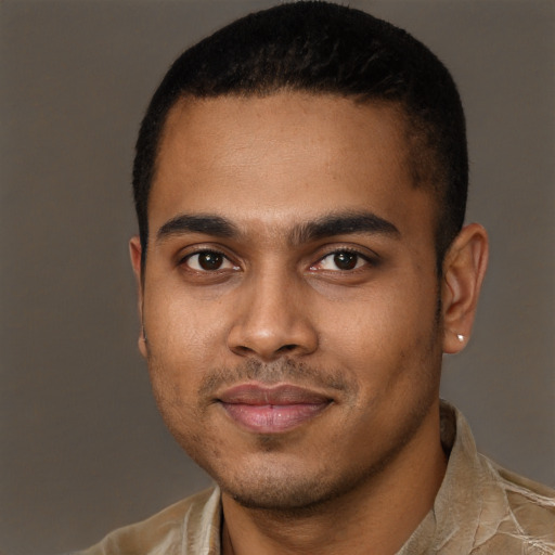 Joyful black young-adult male with short  black hair and brown eyes