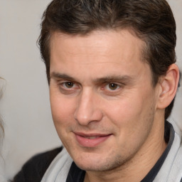 Joyful white adult male with short  brown hair and brown eyes