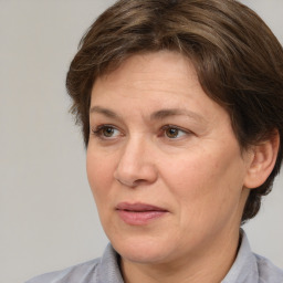 Joyful white adult female with medium  brown hair and grey eyes