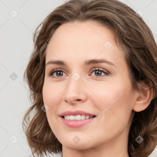 Joyful white young-adult female with medium  brown hair and green eyes