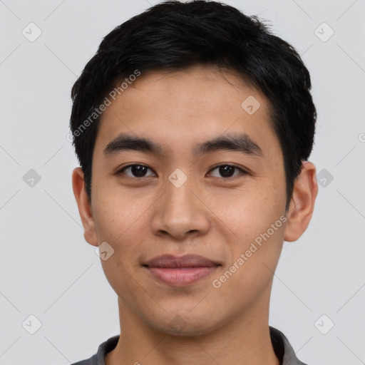 Joyful asian young-adult male with short  black hair and brown eyes