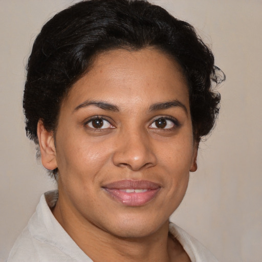 Joyful latino young-adult female with short  brown hair and brown eyes