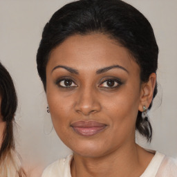 Joyful black young-adult female with medium  brown hair and brown eyes