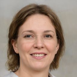 Joyful white adult female with medium  brown hair and grey eyes