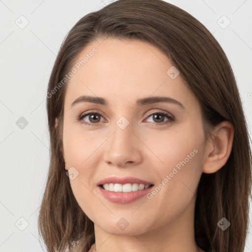 Joyful white young-adult female with long  brown hair and grey eyes