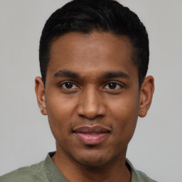 Joyful latino young-adult male with short  black hair and brown eyes